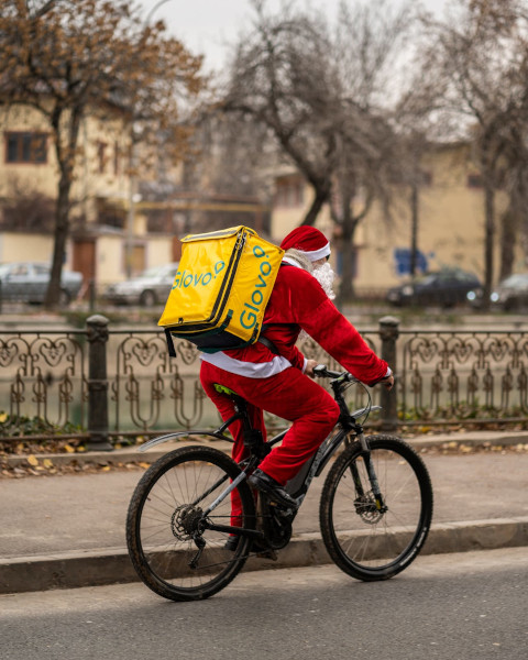 Peste 100 de curieri Glovo vor livra comenzi îmbrăcați în Moș Crăciun în 7 orașe din țară