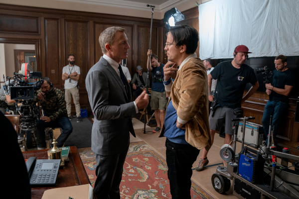 Daniel Craig (James Bond) and director Cary Joji Fukunaga on the set of NO TIME TO DIE, an EON Productions and Metro-Goldwyn-Mayer Studios film Credit: Nicola Dove © 2021 DANJAQ, LLC AND MGM. ALL RIGHTS RESERVED.