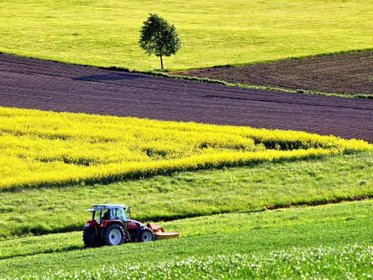 Tractor in agricultural land. Free public domain CC0 image.